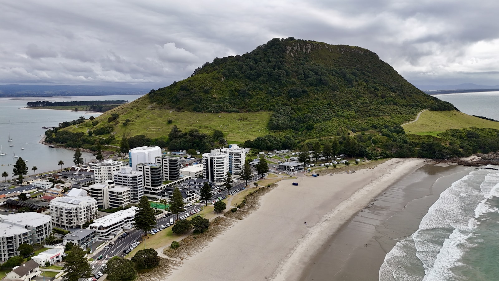 an aerial view of a city next to the ocean